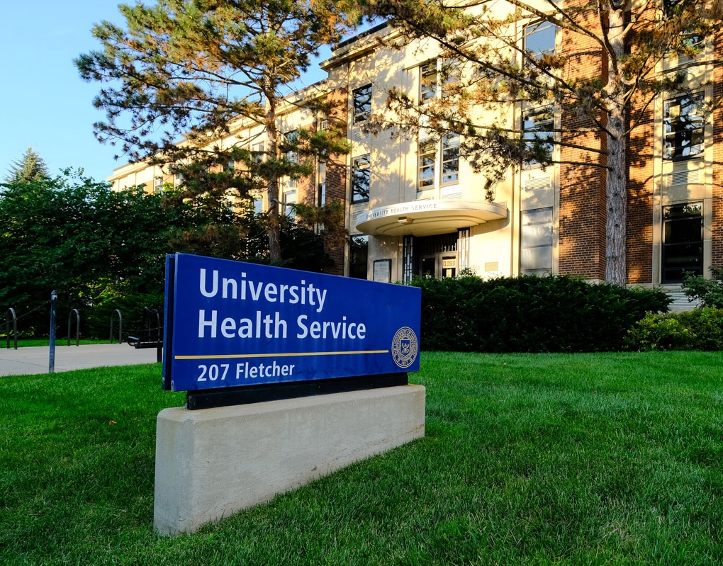 Entrance of the University Health Services building with a name and address sign.