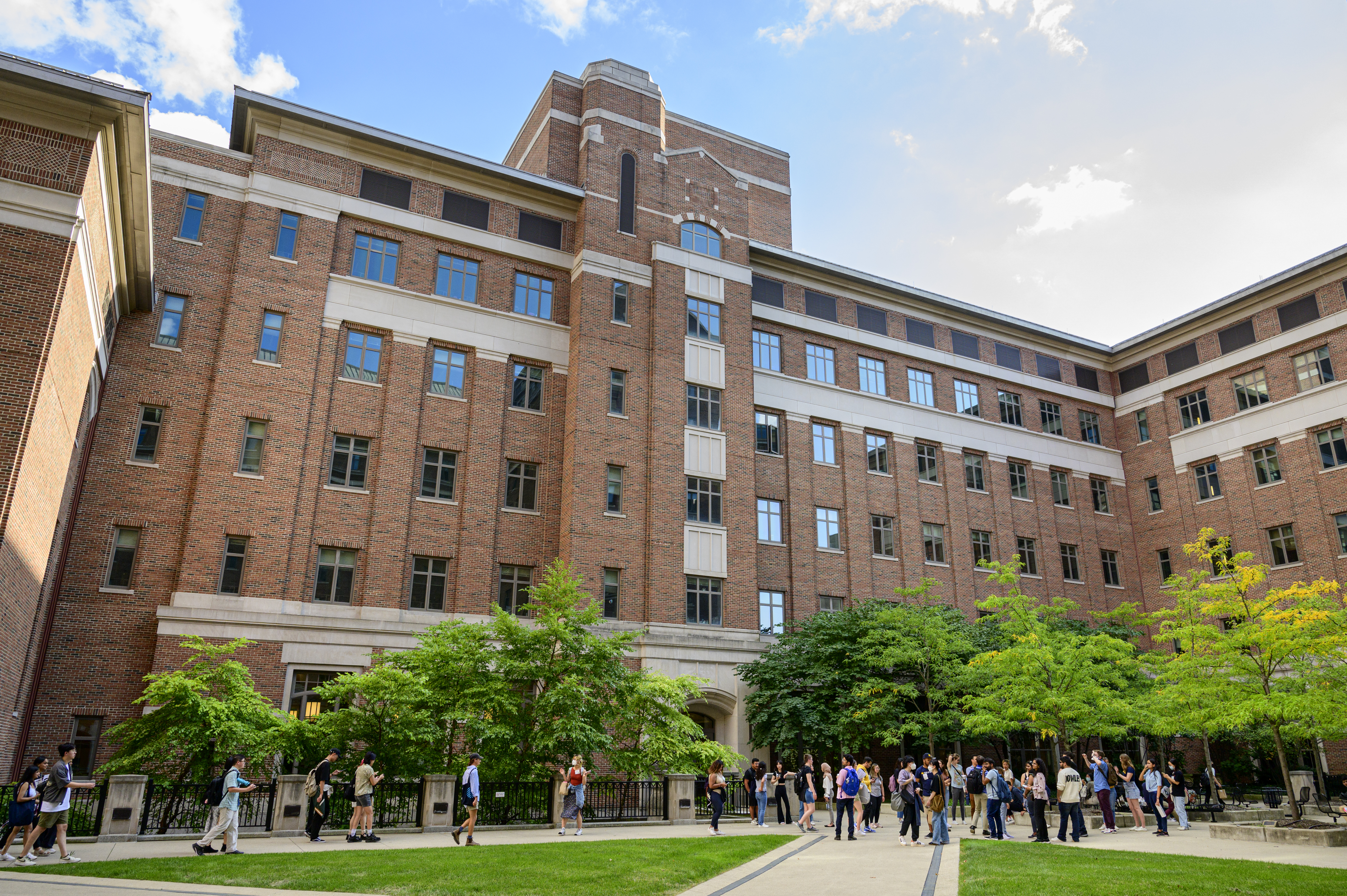 People stand in the UM North Quad courtyard.