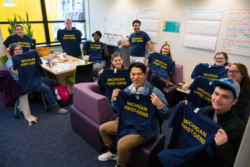 Students posing with 'Michigan First-Gen' t-shirt.